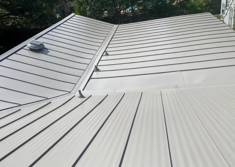 Solar attic fan installed on a metal roof for Roof Ventilation in Wawarsing