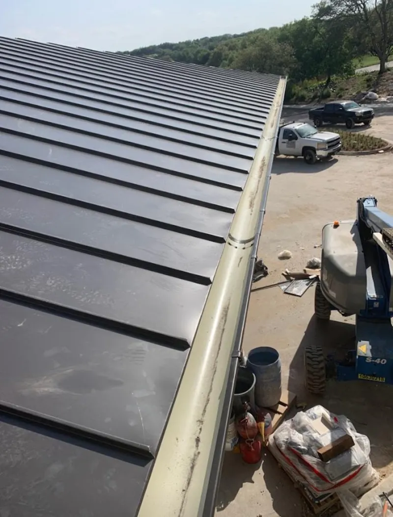 Standing seam panel and gutter detail on a metal roofing jobsite in Wawarsing
